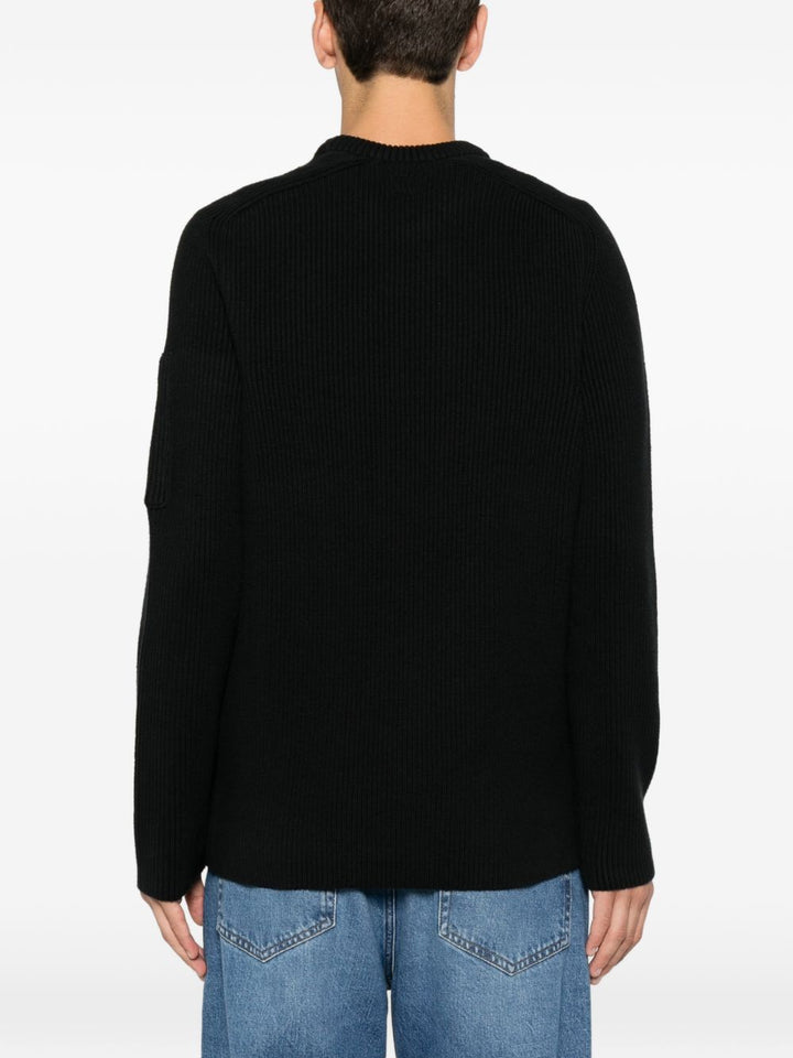Maglione nero girocollo in cotone a coste con dettaglio Lente 