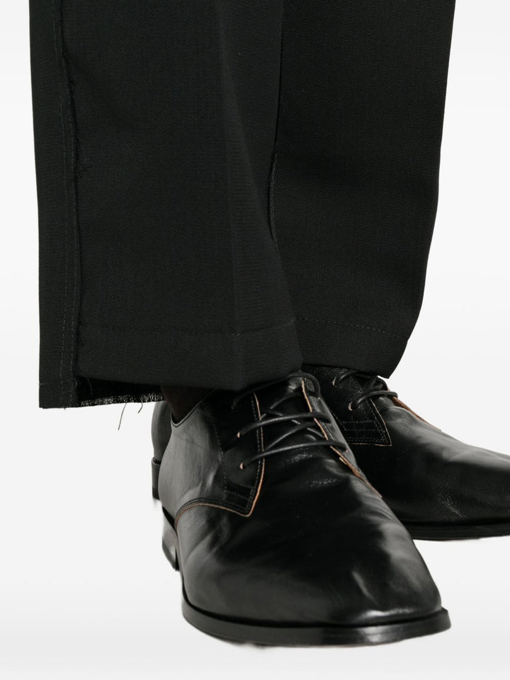 Pantaloni neri in lana vergine con cuciture a contrasto 