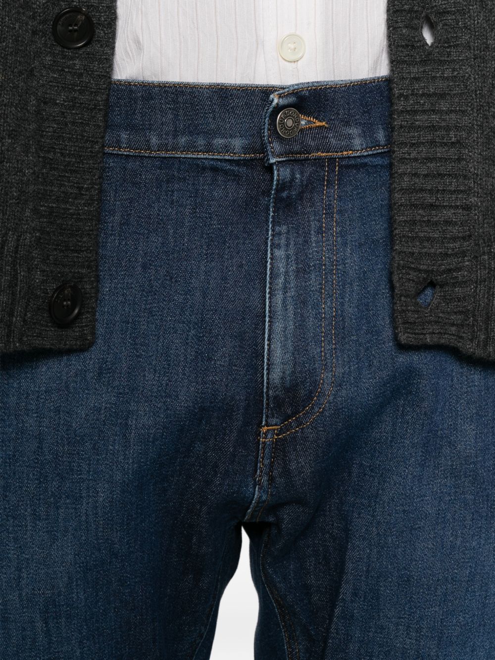 Jeans con impunture a contrasto e logo blu 