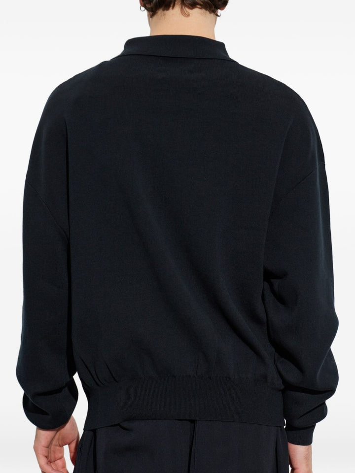 Polo nera con mezza zip 
