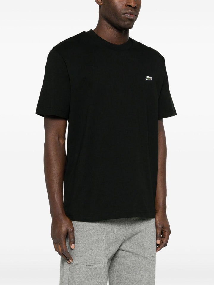 T-shirt nera con applicazione logo 