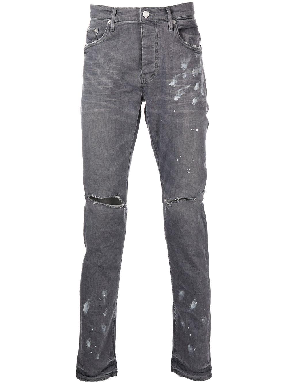 Jeans slim con effetto vissuto e dettaglio vernice 