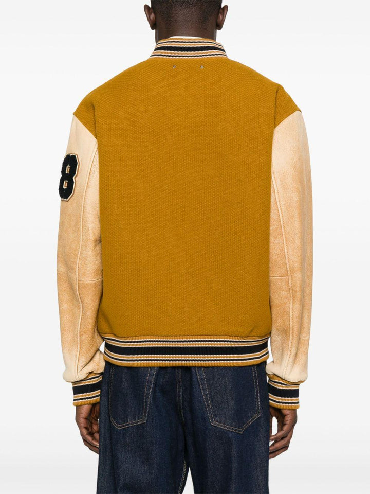 Giacca giallo mostarda con maniche in pelle e applicazione varsity 