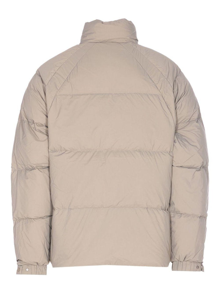 Piumino con collo a imbuto beige 