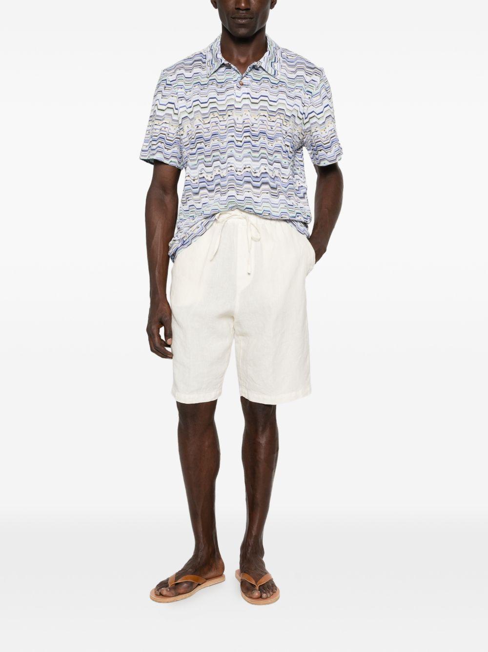 Polo light blu con motivo a zig zag 