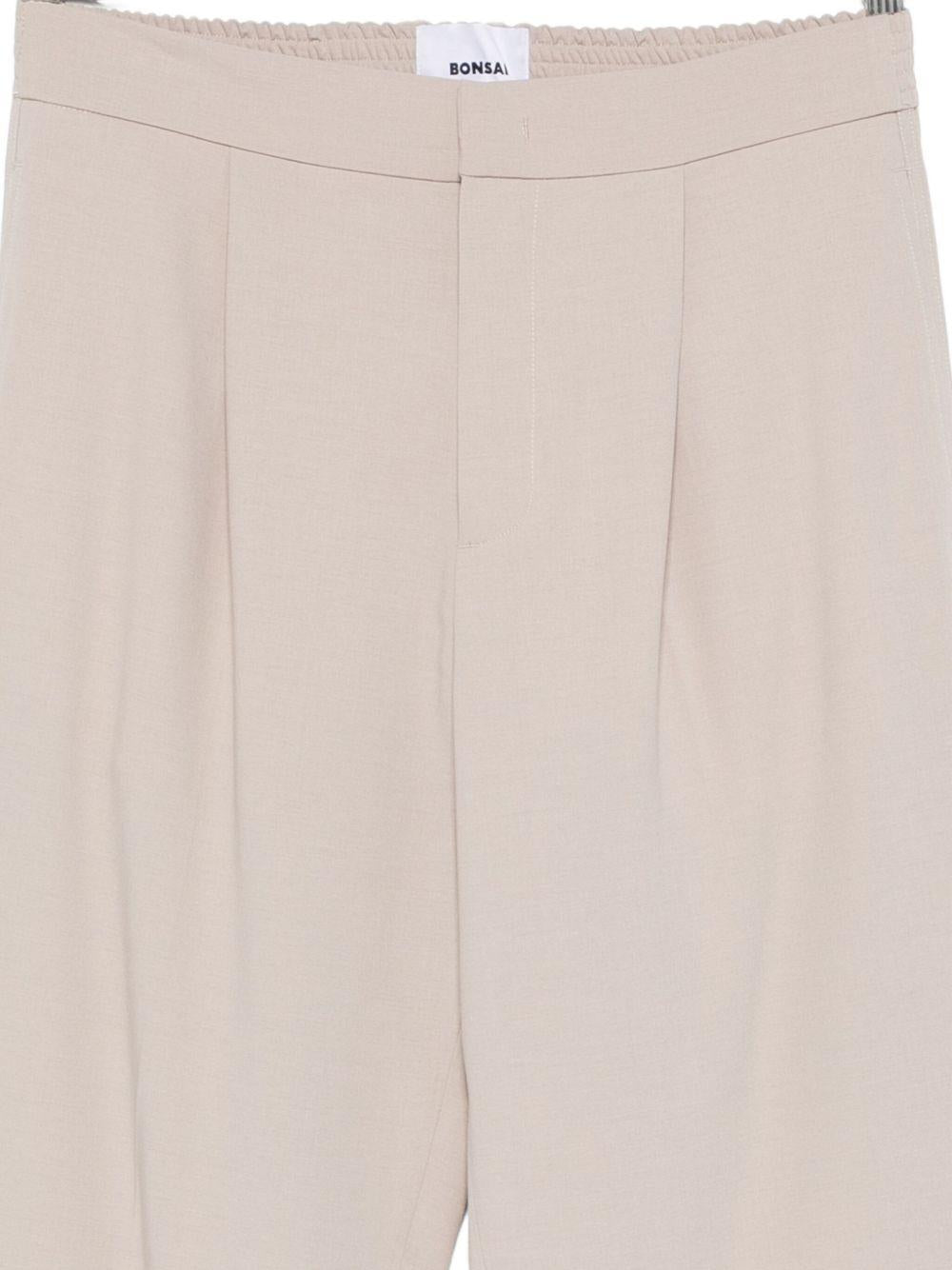 Pantaloni con piega beige 