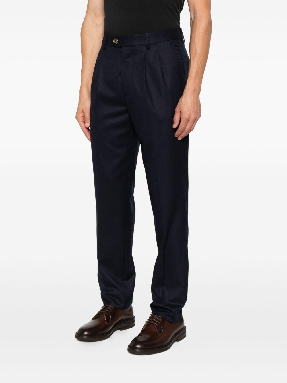 Pantaloni blu scuro in lana plissettati con patta e tasche a filetto 