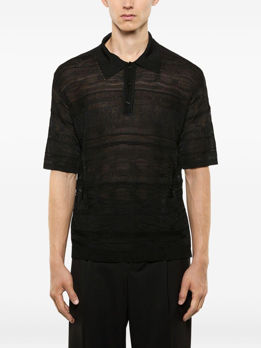 Polo nera in maglia semi trasparente 