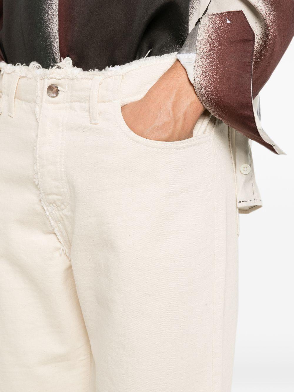 Jeans panna con orli a taglio vivo 
