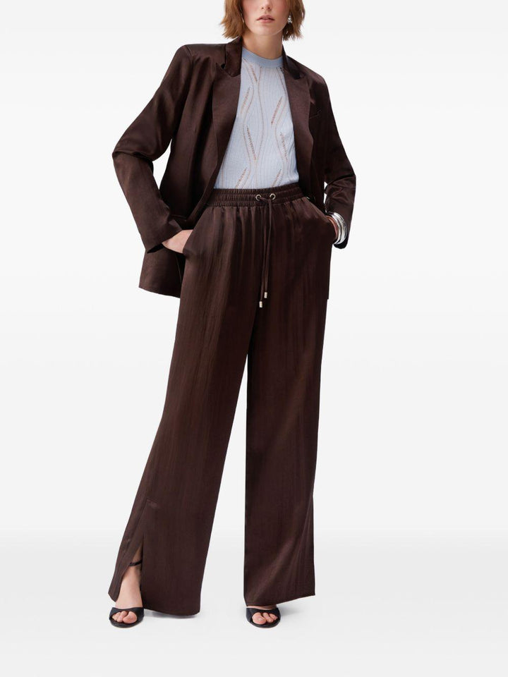 Pantaloni svasati con placca logo 