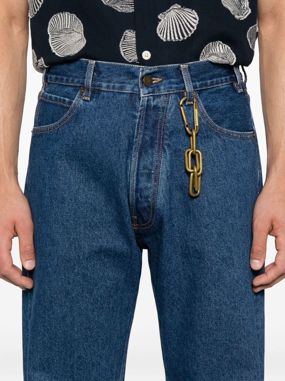 Jeans blu con orli sfrangiati e dettaglio a catena 
