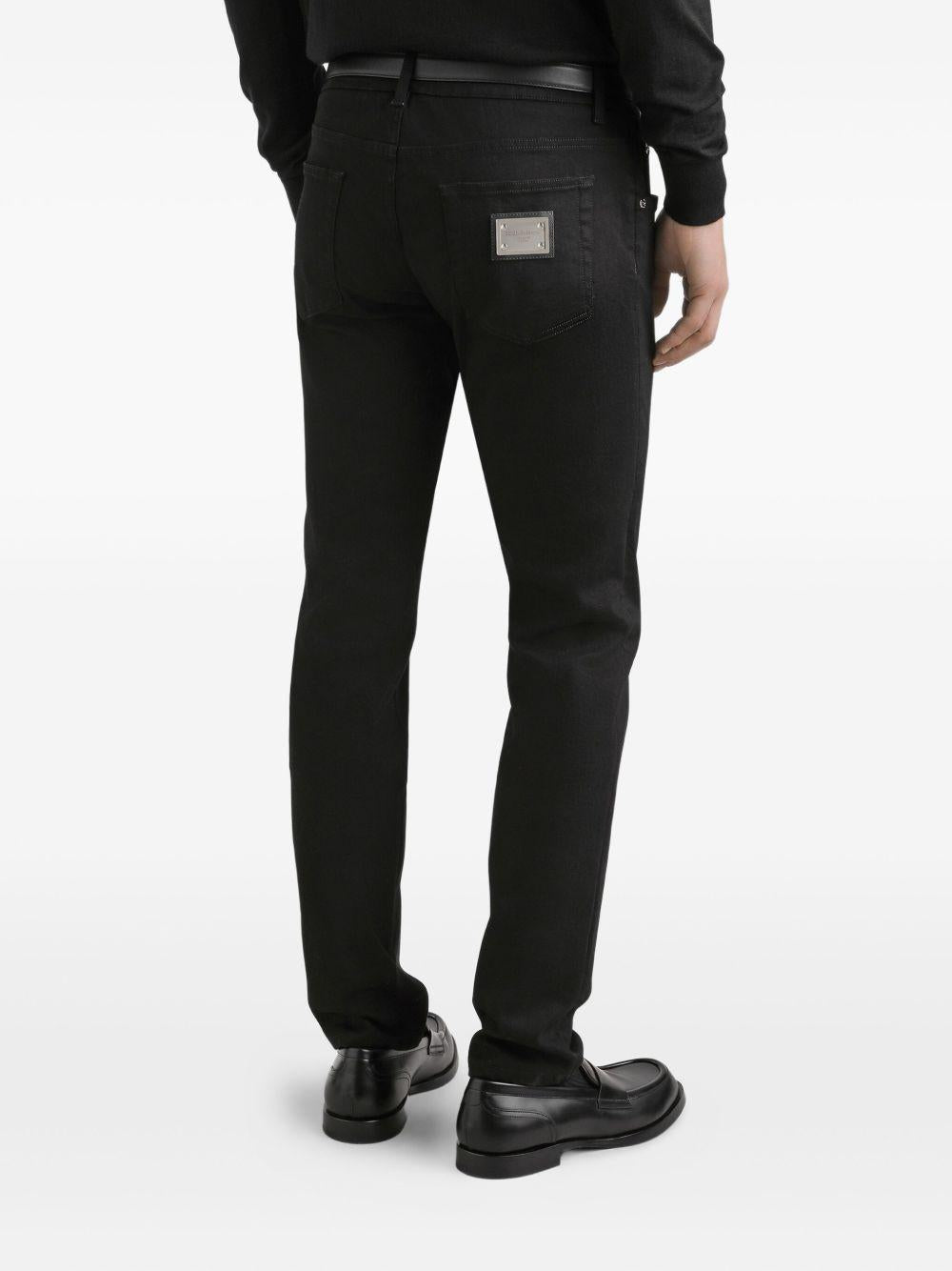 Jeans neri in cotone con placca logo 