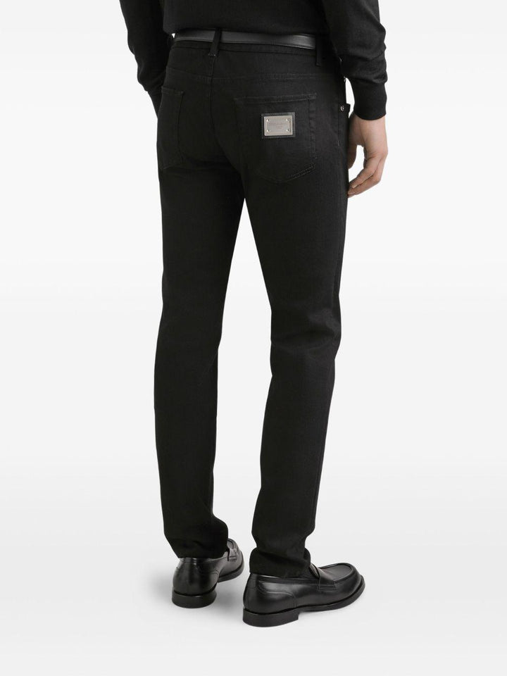 Jeans neri in cotone con placca logo 