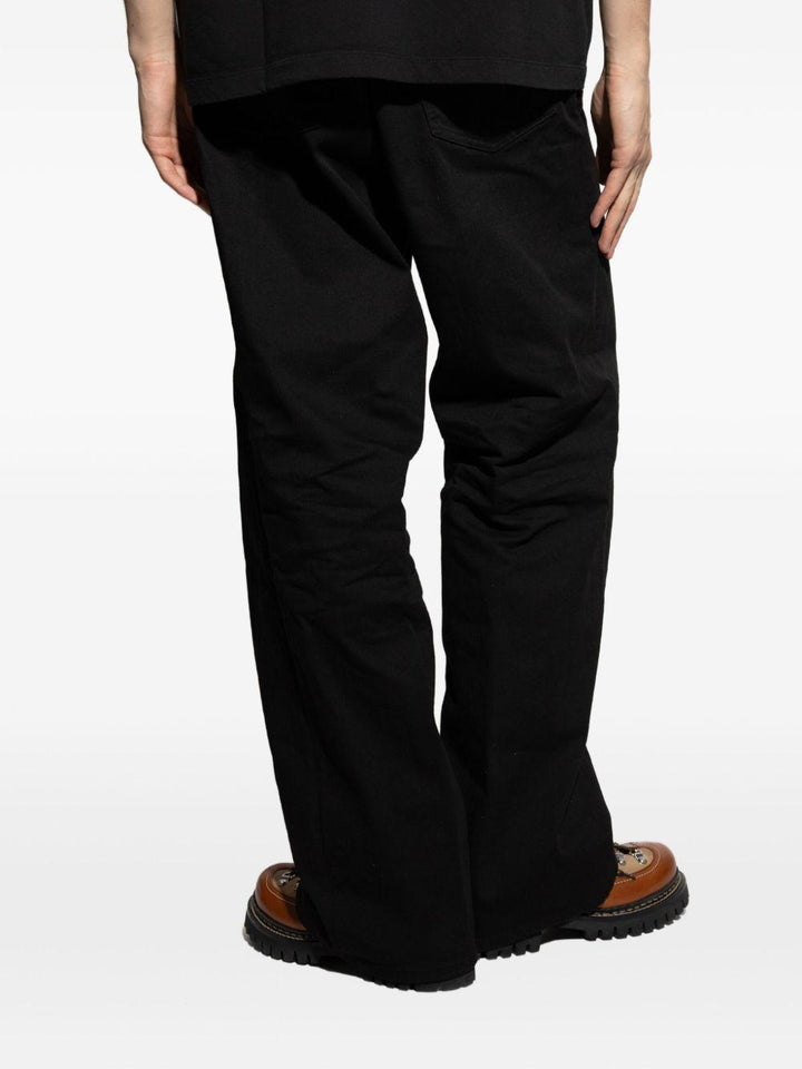Jeans neri a vita media con applicazione logo 