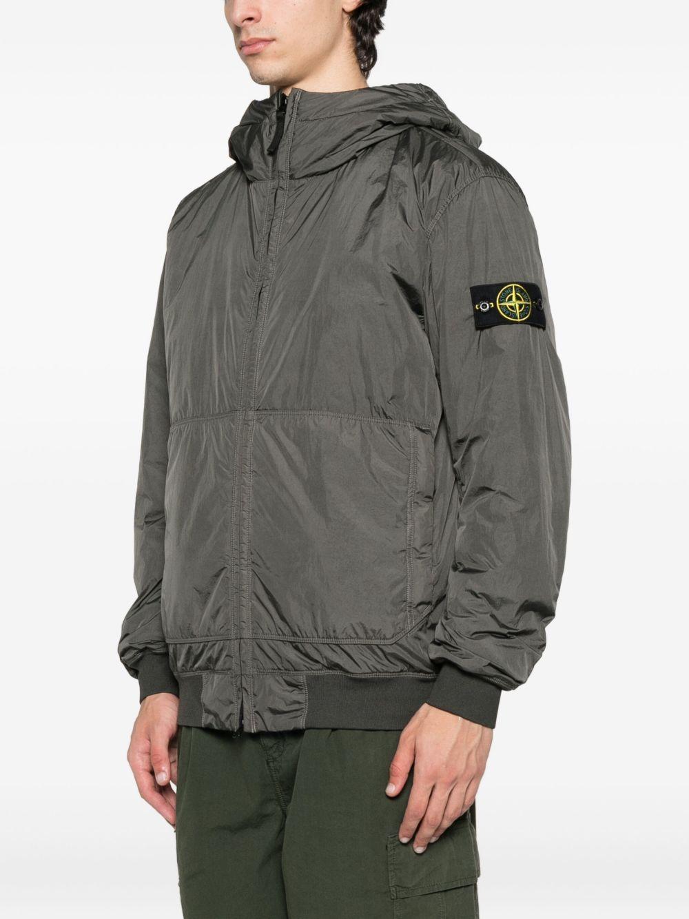 Bomber grigio con cappuccio e applicazione Compass 